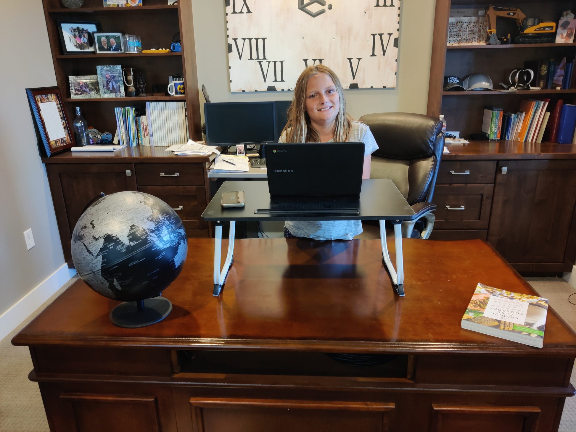 Young girl standing at tale top fold down desk